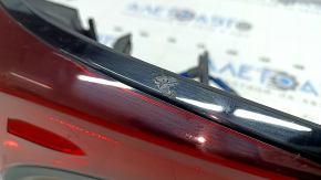 The upper right fender light of a Toyota Prius 50 19-22 is covered in glue and has scratches.