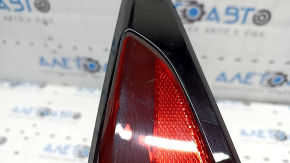 The upper right fender light of a Toyota Prius 50 19-22 is covered in glue and has scratches.