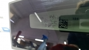 The front panoramic glass of a Hyundai Tucson 22-26 has a torn seal, a chip, and a worn coating.