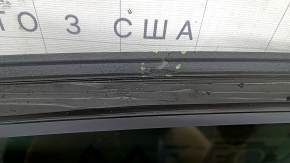 The front panoramic glass of a Hyundai Tucson 22-26 has a torn seal, a chip, and a worn coating.