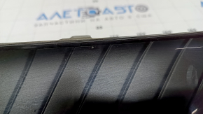 The radiator grille of the Toyota Venza 21-24 is cracked and chipped.