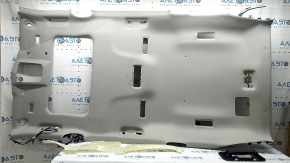 The headliner of a 20-22 Toyota Highlander is gray and has creases under the sunroof. The brackets have come loose and need cleaning.