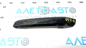 The outer rear left door handle trim of the Audi Q5 80A 18-24 has a crack, scratches, and broken fasteners.