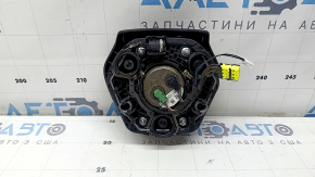 The airbag in the driver's steering wheel of the BMW 3 G20 19-26 is black and scratched.