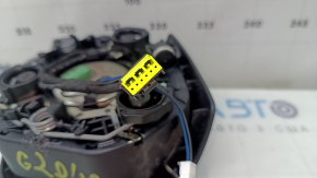 The airbag in the driver's steering wheel of the BMW 3 G20 19-26 is black and scratched.