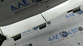 The right front bumper trim of a Volvo XC90 16-19 is cracked and chipped.