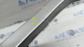 The right front bumper trim of a Volvo XC90 16-19 is cracked and chipped.