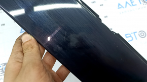 The front right side door trim panel of a Volvo XC90 16-26 is worn out.
