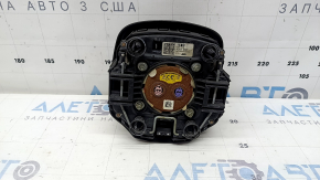 The Kia Sportage 23-25 driver's steering wheel airbag is black, melted, and has a rusty piston.