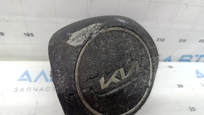 The Kia Sportage 23-25 driver's steering wheel airbag is black, melted, and has a rusty piston.