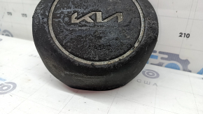 The Kia Sportage 23-25 driver's steering wheel airbag is black, melted, and has a rusty piston.