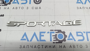 The SPORTAGE emblem on the Kia Sportage 23-26 trunk door