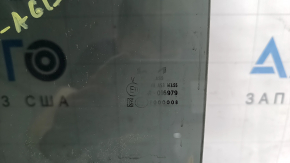 The rear left door glass of a Kia Sportage 23-26 is tinted, the markings are faded.