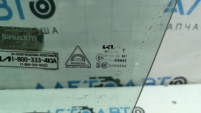 The front left door glass of a Kia Sportage 23-24 has burnt out markings.