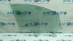 The front left door glass of a Kia Sportage 23-24 has burnt out markings.