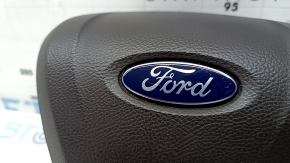 The steering wheel airbag for the driver's side of a Ford Fusion mk5 17-20 is brown and scratched.