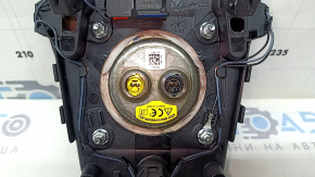 The steering wheel airbag for the driver's side of a Ford Fusion mk5 17-20 is brown and scratched.