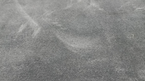 The trunk floor of the Audi A5 F5 19-25 5D is black and dented.