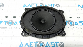 The front right door speaker of a Subaru Forester 25-26 is dented.