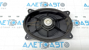 The front right door speaker of a Subaru Forester 25-26 is dented.