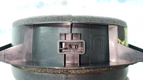 The front right door speaker of a Subaru Forester 25-26 is dented.