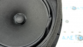 The front right door speaker of a Subaru Forester 25-26 is dented.