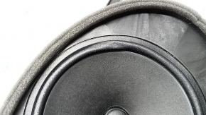 The front right door speaker of a Subaru Forester 25-26 is dented.
