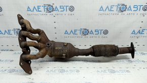 The exhaust manifold with a catalytic converter on a Ford Fusion mk5 17-20 hybrid is rusty and the mesh is torn.