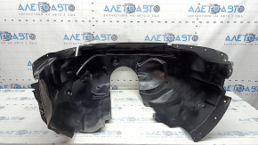 The front left fender liner of a Ford Fusion mk5 17-20 is torn and worn.