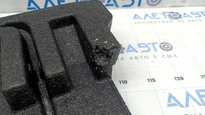The left trunk foam of a Subaru Forester 25-26 is dented.