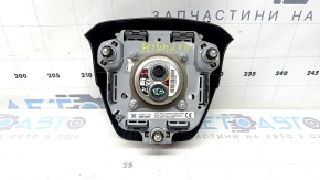 The Toyota Highlander 20-22 driver's steering wheel airbag is black and scratched.