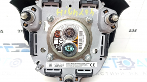 The Toyota Highlander 20-22 driver's steering wheel airbag is black and scratched.