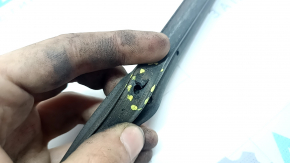 The front left door seal of a Toyota Highlander 20-26 is torn.