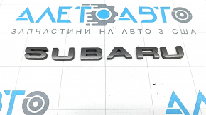 The SUBARU emblem is on the trunk door of a 2016 Subaru Forester.