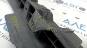 The rear bumper absorber of a Toyota Highlander 20-26 is dented and cracked.