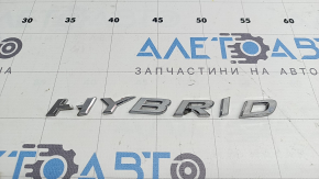 The emblem with the HYBRID inscription on the rear right door of a Lexus UX250h 19-22 is broken. The letter "H" is broken.