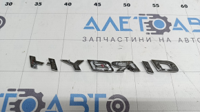 The emblem with the HYBRID inscription on the rear right door of a Lexus UX250h 19-22 is broken. The letter "H" is broken.