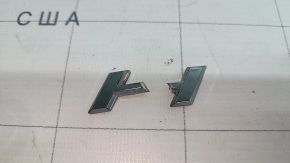 The emblem with the HYBRID inscription on the rear right door of a Lexus UX250h 19-22 is broken. The letter "H" is broken.
