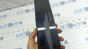 The rear right side door trim for a Lexus UX 19-26 is missing a seal, the fastener is broken, and it's covered in glue.