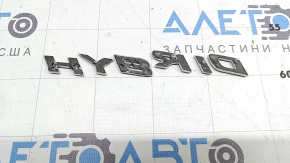 Emblem with the inscription HYBRID on the rear left door of the Lexus UX250h 19-22