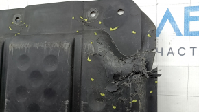 The rear engine guard of the Mercedes W213 E 17-23 AWD is cracked, worn, and missing a fragment.