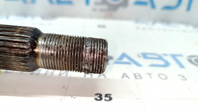 The rear right half shaft of a Lexus UX200 UX250h 19-24 is rusty and has stripped threads.