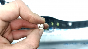 The right Kia Sorento 21-26 trunk lid position sensor has broken mounts.