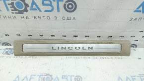 Lincoln MKZ 17-20 front left door sill plate, chrome with backlight, beige, scratches, needs cleaning