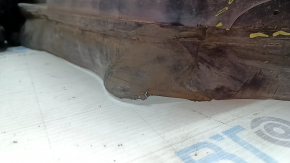 The front right fender liner of a Lincoln MKZ 17-18 is worn and broken.