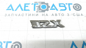 The "XSE" emblem on the tailgate of a Toyota Rav4 19-25, gloss black, chipped