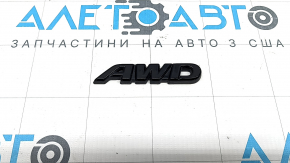 Emblem with the inscription "AWD" on the rear right door of a Toyota Rav4 19-22, glossy black