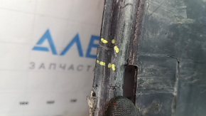 The left underbody protection of a VW Tiguan 18-24 is worn, cracked, and the mount is broken