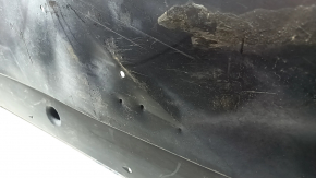 The left underbody protection of a VW Tiguan 18-24 is worn, cracked, and the mount is broken