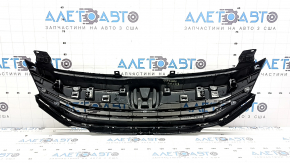 The base of the radiator grille of the Honda Accord 16-17 hybrid, with the emblem, is cracked, the fastener is broken